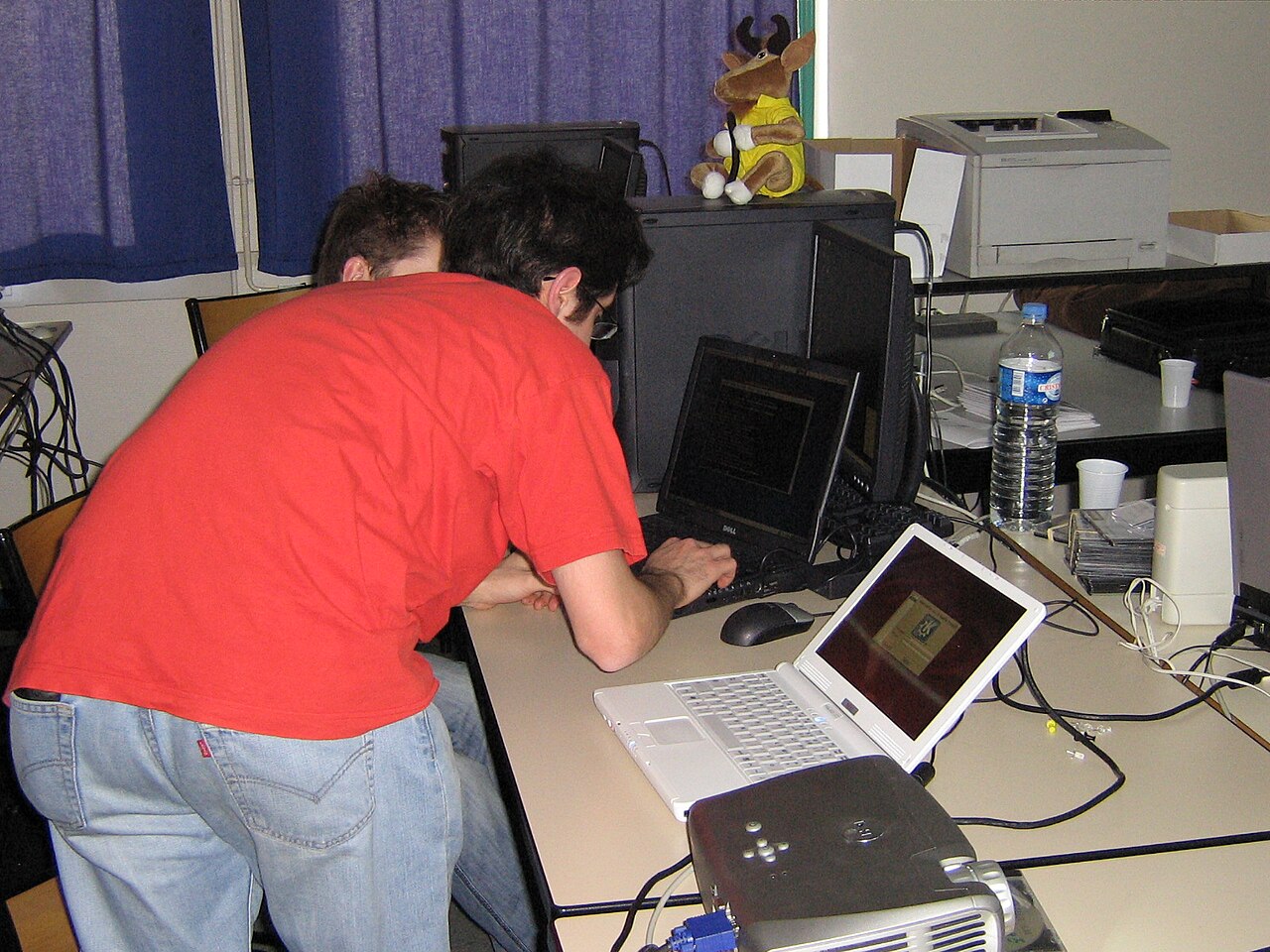 Inside a modern data center featuring network servers and Broadcom-branded hardware related to semiconductor and networking technology