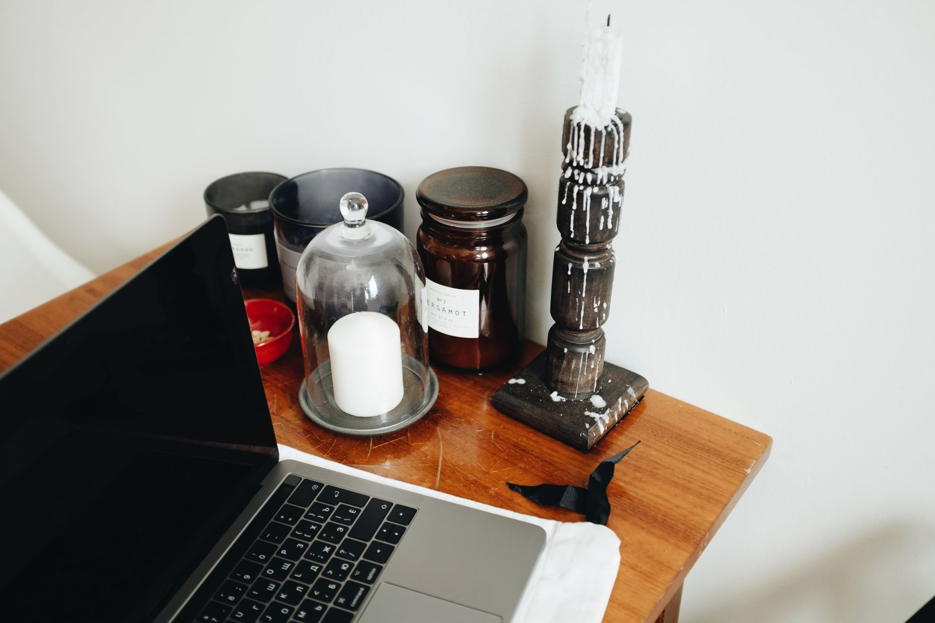 Close-up of a laptop on a desk showing an online crossword puzzle alongside business study notes and a cup of coffee.