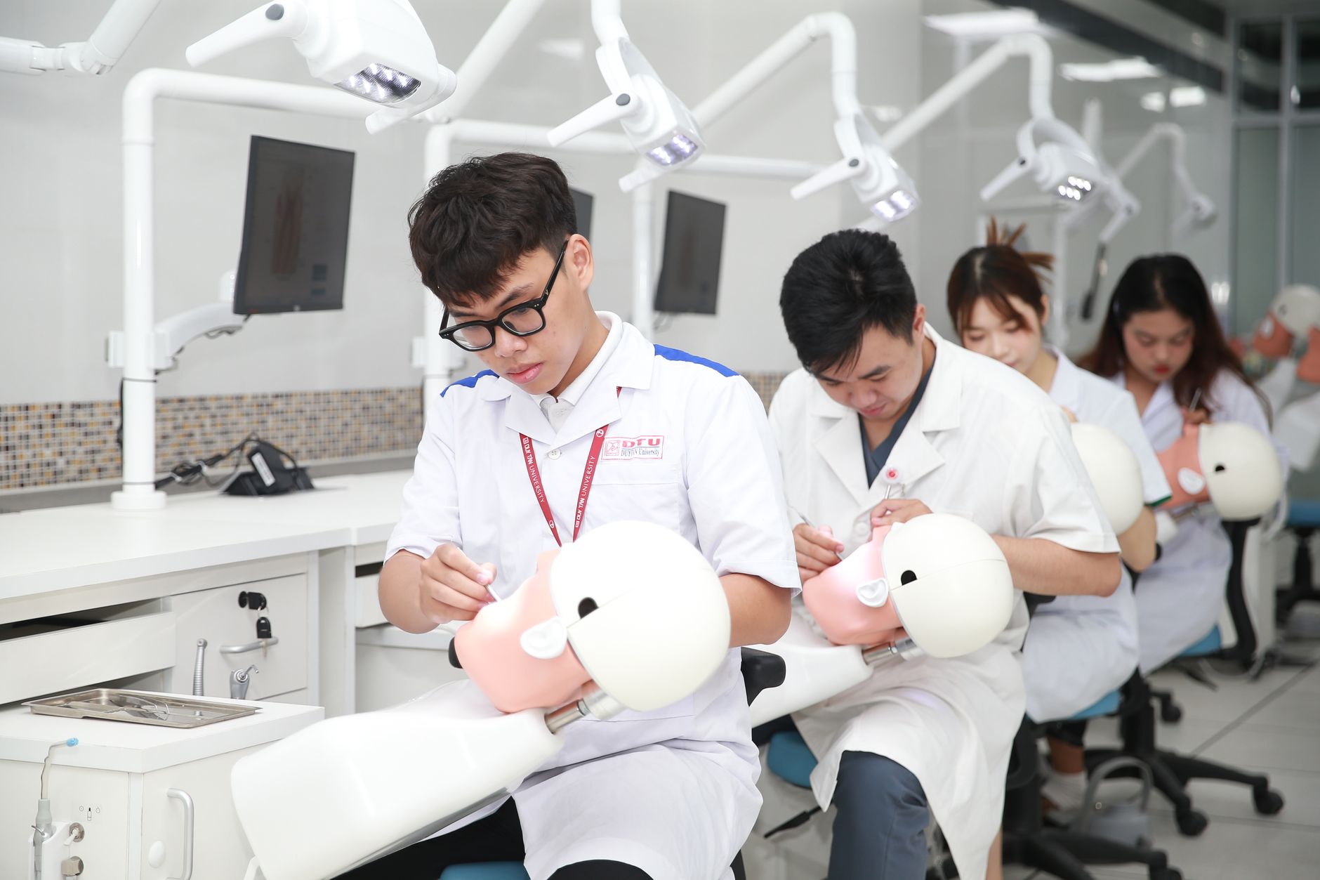 Students receiving hands-on training in a Penn Commercial technical lab, working with industrial equipment and tools under instructor supervision.
