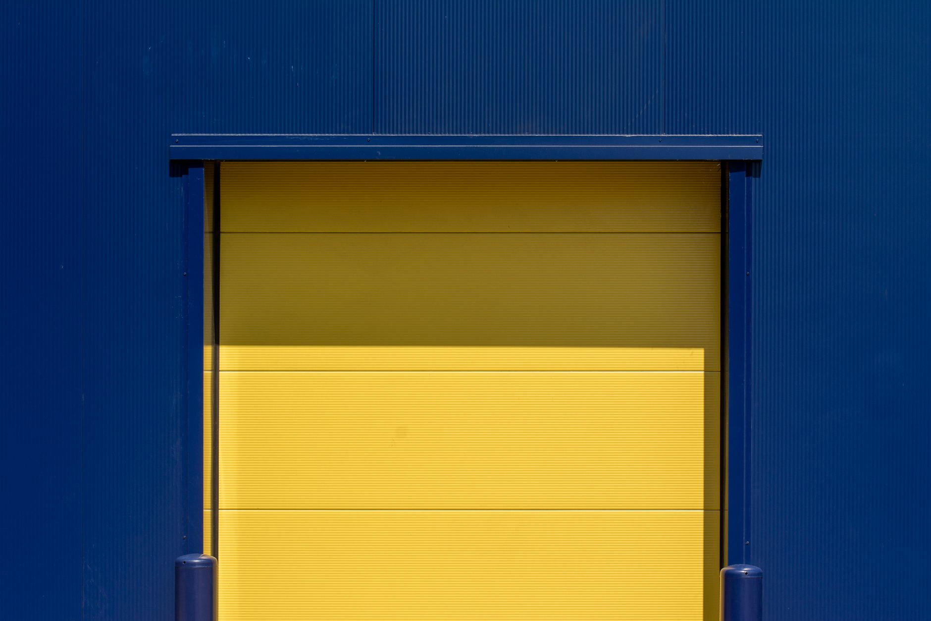 Modern warehouse loading bays with a delivery truck parked at a loading dock in an industrial estate